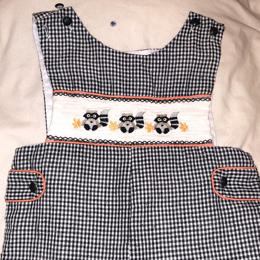 Autumn long all with raccoon embroidered on the front With orange piping as trim